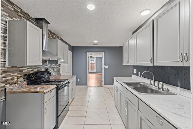 kitchen featuring sink, backsplash, electric range, a textured ceiling, and wall chimney exhaust hood