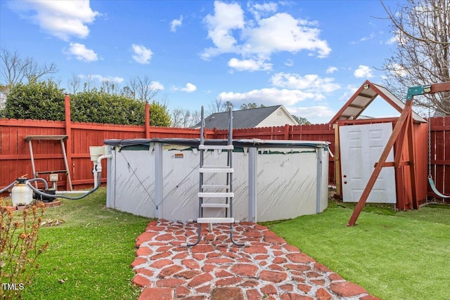 view of outdoor structure featuring a lawn and a covered pool