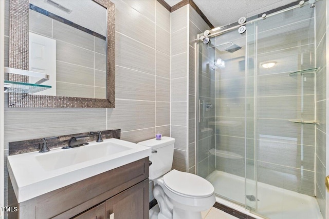 bathroom featuring walk in shower, toilet, tile walls, a textured ceiling, and vanity