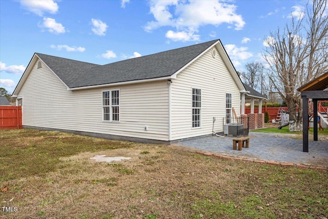 view of side of home featuring central AC unit, a yard, and a patio area