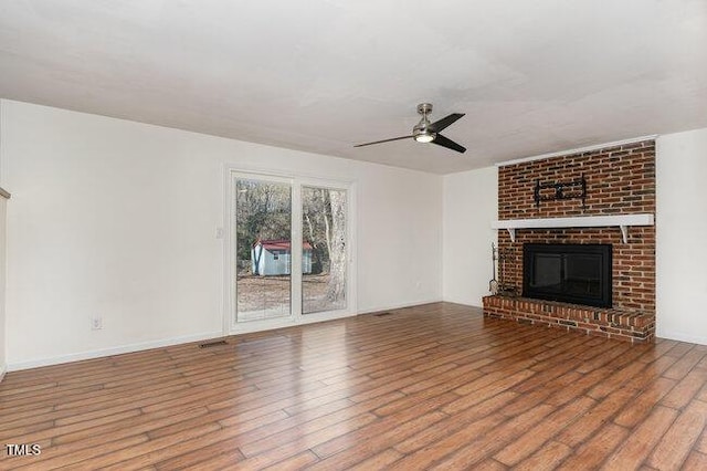 unfurnished living room with hardwood / wood-style floors, a fireplace, and ceiling fan