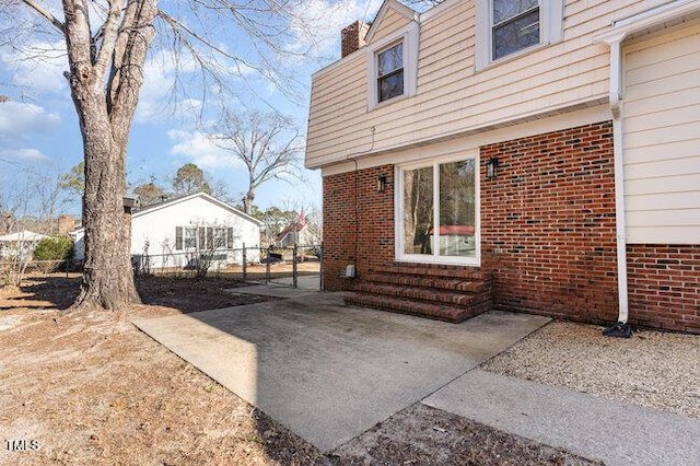 view of property exterior with a patio area