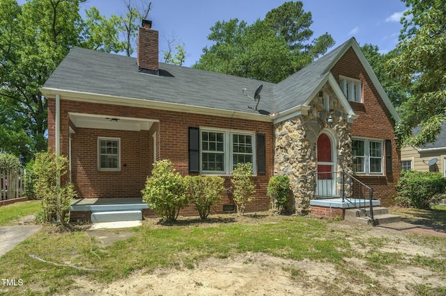 945 Sycamore St, Rocky Mount, NC 27801 - view of front of home with brick siding, a chimney, and a shingled roof