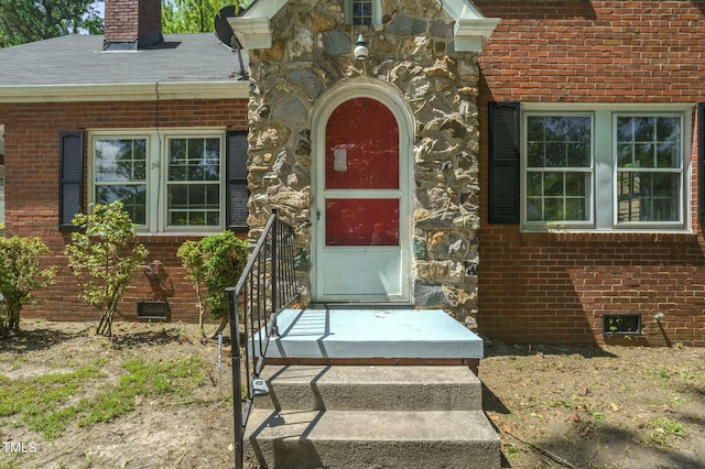 945 Sycamore St, Rocky Mount, NC 27801 - view of exterior entry featuring a chimney, brick siding, stone siding, and crawl space