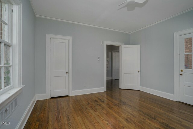 945 Sycamore St, Rocky Mount, NC 27801 - unfurnished bedroom with crown molding, wood finished floors, baseboards, and multiple windows