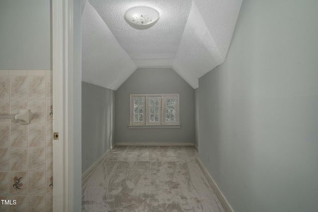 945 Sycamore St, Rocky Mount, NC 27801 - bonus room featuring carpet, a textured ceiling, vaulted ceiling, and baseboards