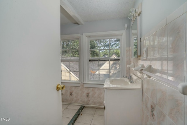 945 Sycamore St, Rocky Mount, NC 27801 - bathroom featuring vanity, tile patterned floors, tile walls, and a textured ceiling