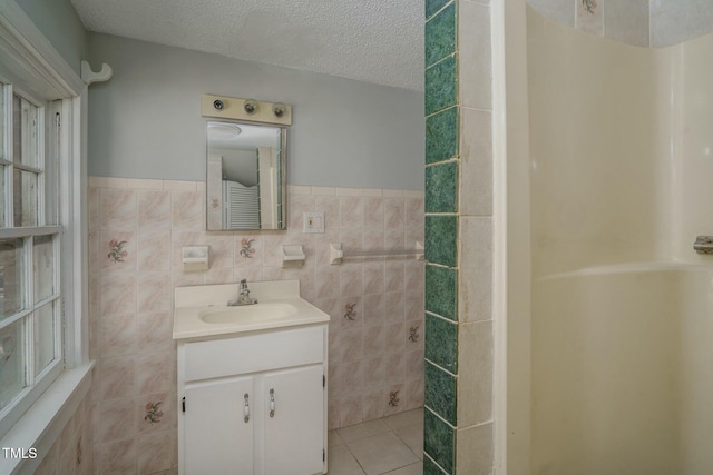 945 Sycamore St, Rocky Mount, NC 27801 - full bath with tile walls, vanity, tile patterned flooring, wainscoting, and a textured ceiling
