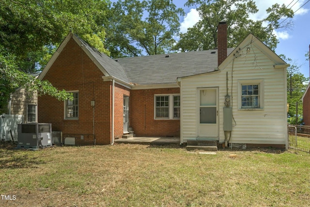 945 Sycamore St, Rocky Mount, NC 27801 - rear view of property featuring cooling unit, entry steps, brick siding, a chimney, and a shingled roof