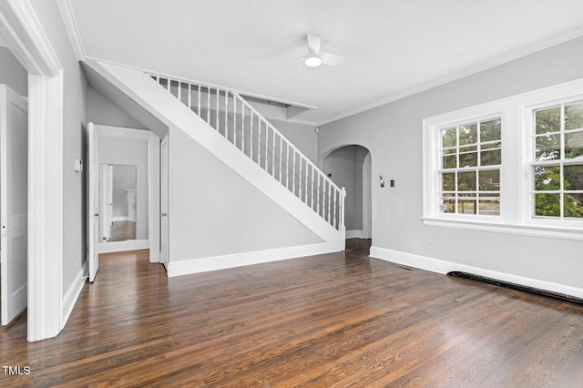 945 Sycamore St, Rocky Mount, NC 27801 - unfurnished living room featuring arched walkways, dark wood finished floors, ornamental molding, stairway, and baseboards