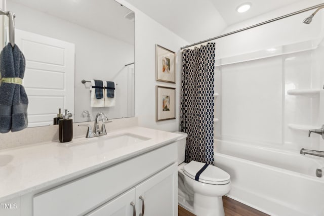 full bathroom featuring hardwood / wood-style flooring, vanity, toilet, and shower / tub combo