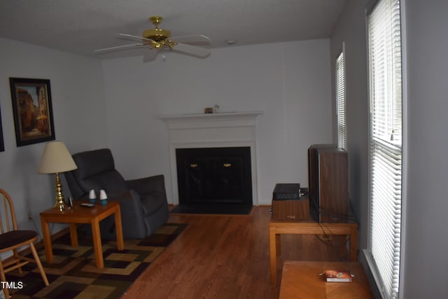 living room featuring dark hardwood / wood-style floors and ceiling fan