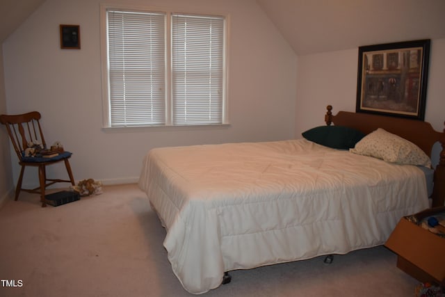 bedroom with vaulted ceiling and light carpet