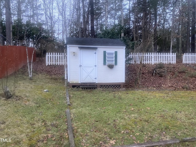 view of outbuilding with a yard