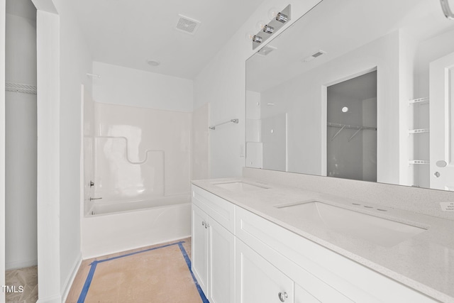 bathroom with vanity and shower / washtub combination