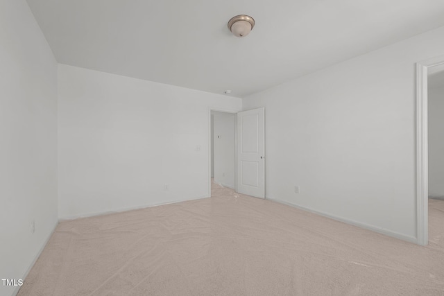 unfurnished room featuring light carpet