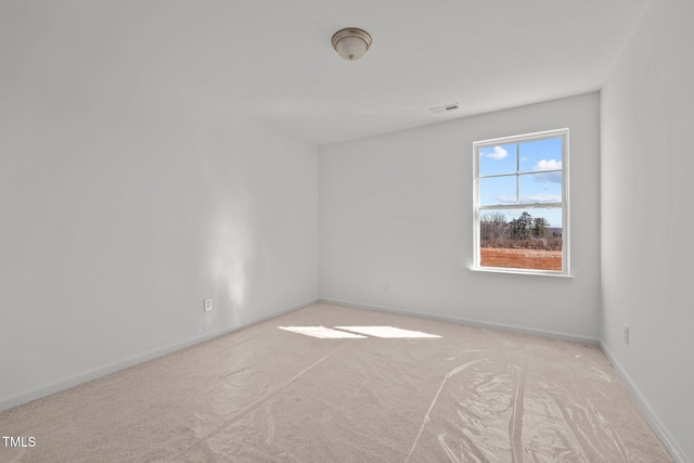 unfurnished room with light carpet