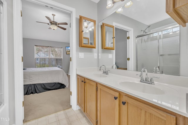 bathroom with vanity, a shower with door, and ceiling fan