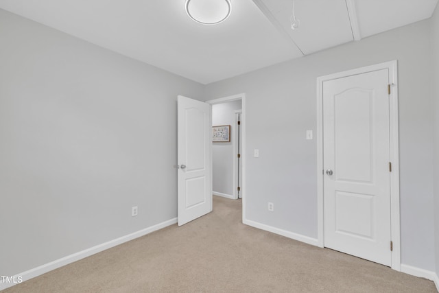 unfurnished bedroom with light colored carpet