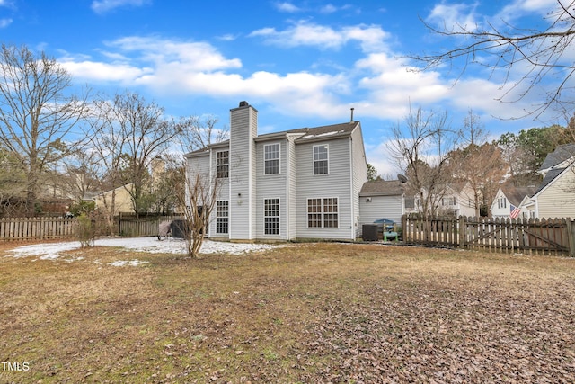 back of property with cooling unit and a lawn