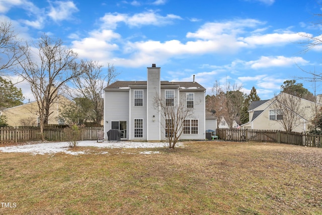 rear view of property with a lawn