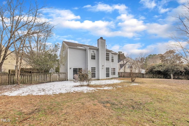 rear view of house featuring a yard