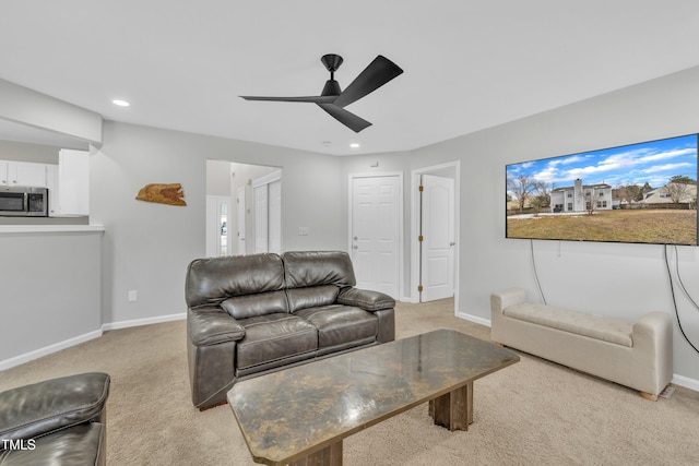 living room featuring ceiling fan and light carpet