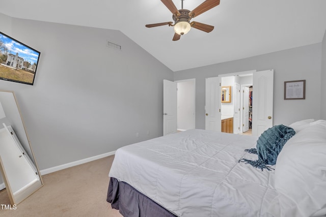 bedroom with light carpet, connected bathroom, lofted ceiling, and ceiling fan