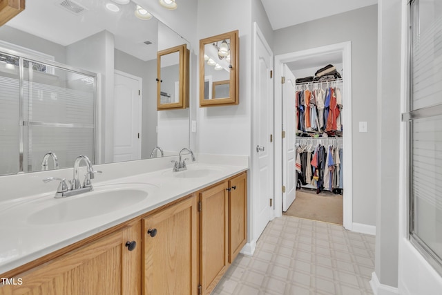 bathroom with vanity and an enclosed shower