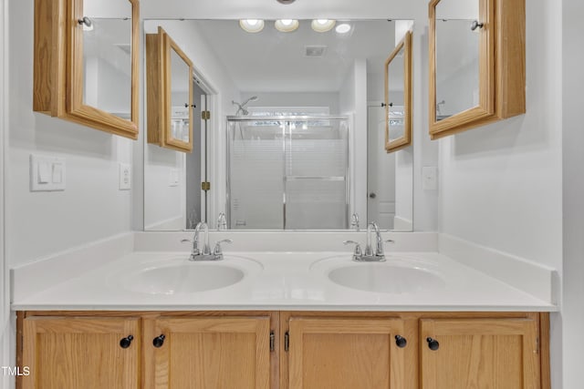 bathroom with vanity and a shower with shower door