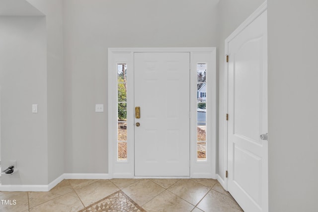 foyer entrance featuring light tile patterned flooring