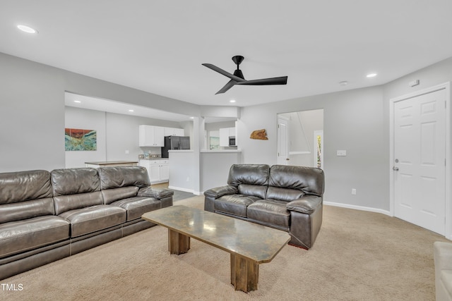 living room featuring ceiling fan and light carpet