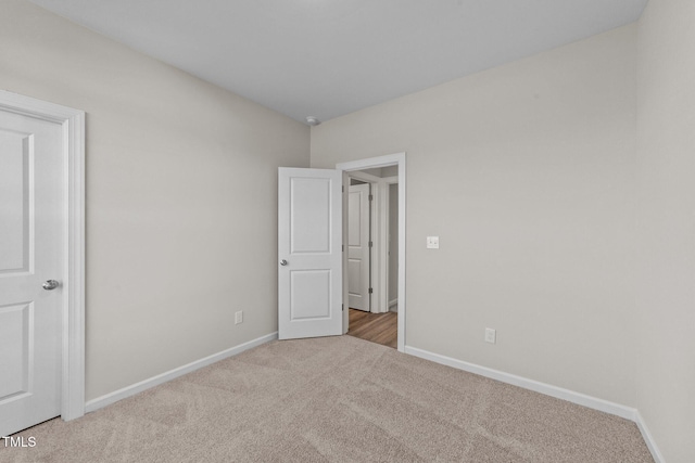 unfurnished bedroom with light colored carpet