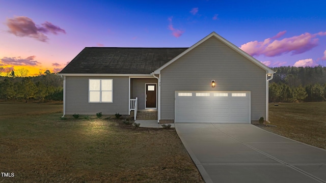 ranch-style house with concrete driveway, a lawn, a garage, and roof with shingles