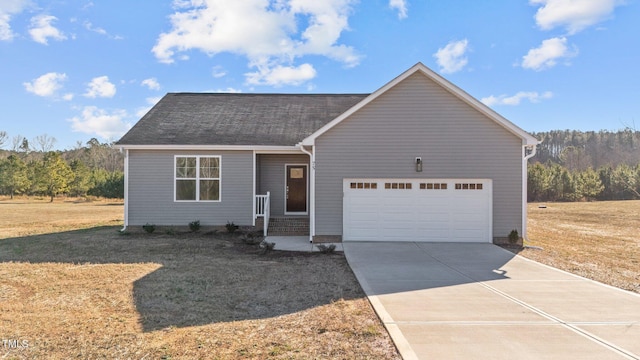 view of front of property with a garage and a front yard