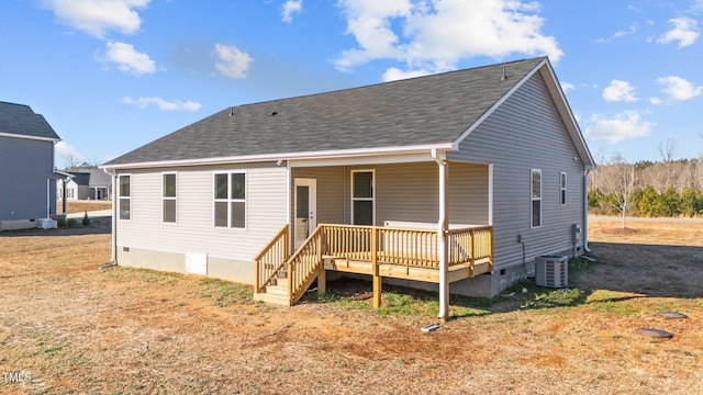 rear view of house featuring a wooden deck and central AC unit