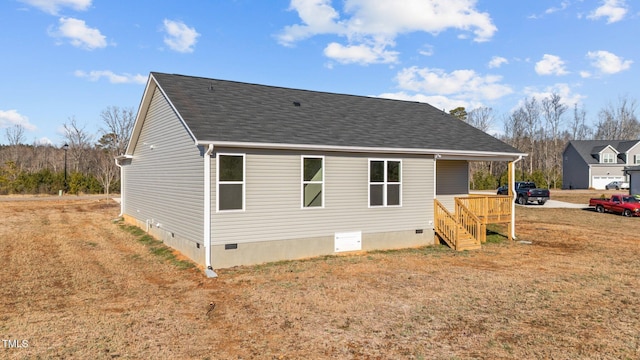 rear view of property featuring a yard and a deck