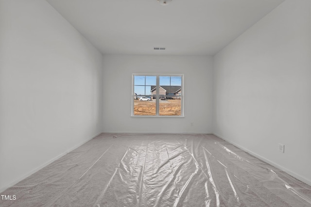 unfurnished room with light carpet