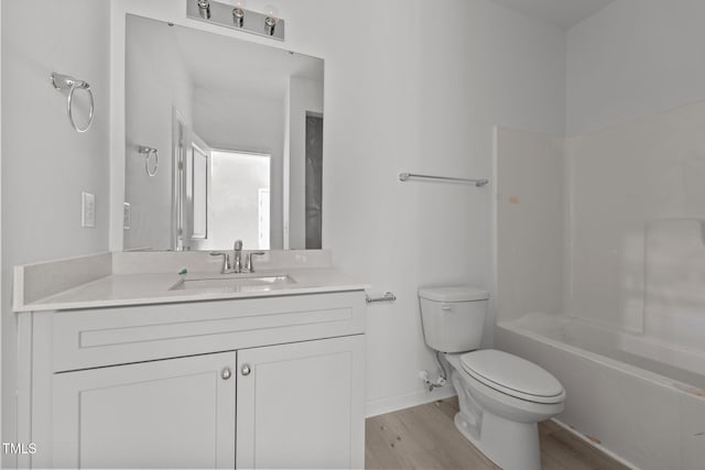 full bathroom featuring hardwood / wood-style flooring, vanity, toilet, and bathing tub / shower combination