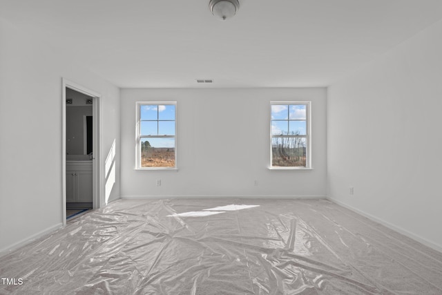 interior space featuring multiple windows and ensuite bath