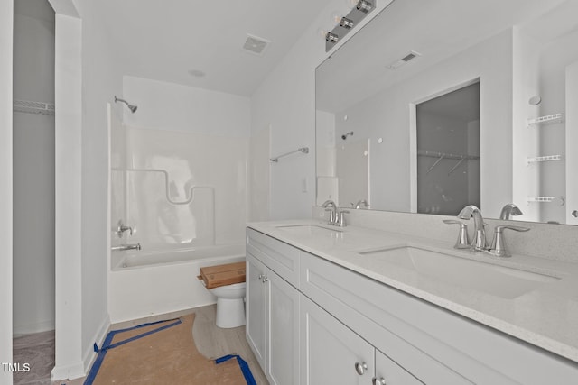 full bathroom with vanity, shower / tub combination, and toilet