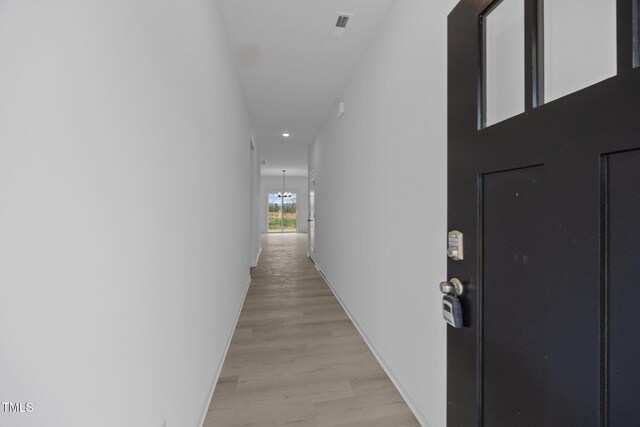 3615 62, Burlington, NC 27217 - corridor featuring light wood-type flooring, baseboards, recessed lighting, and a notable chandelier