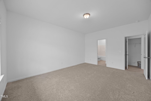 3615 62, Burlington, NC 27217 - unfurnished bedroom featuring baseboards, ensuite bathroom, carpet flooring, and a spacious closet