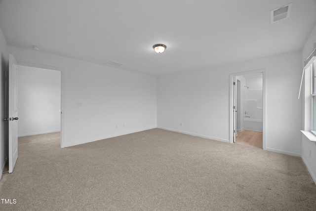 3615 62, Burlington, NC 27217 - unfurnished bedroom featuring baseboards, visible vents, connected bathroom, and light colored carpet