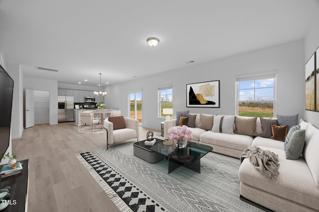 3615 62, Burlington, NC 27217 - living room featuring recessed lighting, visible vents, light wood finished floors, and an inviting chandelier