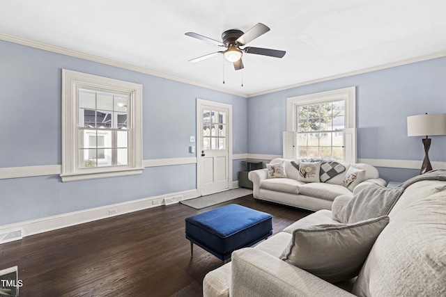 living room with dark wood-type flooring, ornamental molding, and ceiling fan