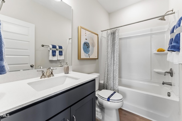 full bathroom featuring vanity, wood-type flooring, toilet, and shower / bath combo with shower curtain