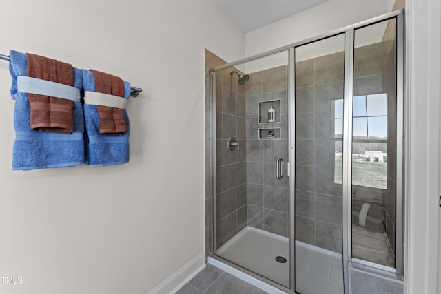 bathroom with tile patterned floors and a shower with shower door