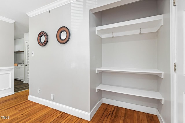 hallway featuring hardwood / wood-style flooring and ornamental molding