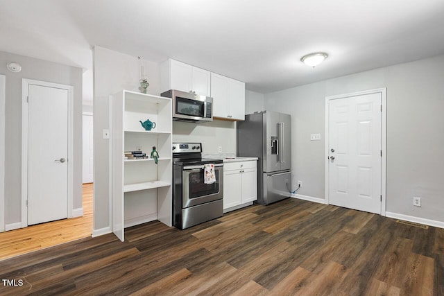 kitchen featuring stainless steel appliances, white cabinetry, and dark hardwood / wood-style flooring